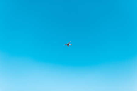 Beautiful clear blue sky with a plane high in the sky. travel conceptの写真素材