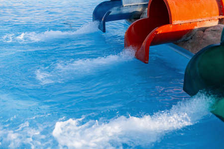 Aqua park with three pipes and blue water in the pool. summer holidays