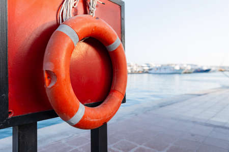 Red lifebuoy against the backdrop of the sea. Support concept and helpの写真素材
