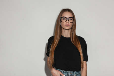 Glamor beautiful young woman model with vintage eyewear glasses in fashion black t-shirt mock-up...