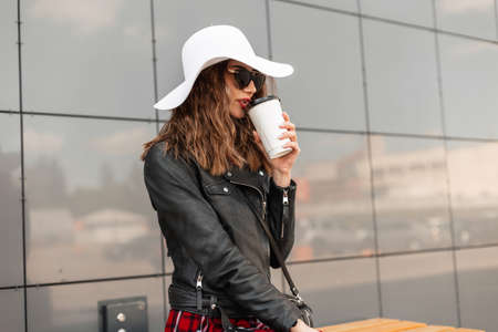 Portrait woman with cup of tea or coffee with red lipstick and pretty smile in summer hat in black...