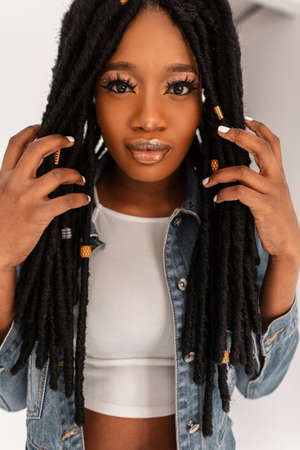 Portrait pretty afro woman with clean skin with sexy lips with cool dreads with makeup in fashion...