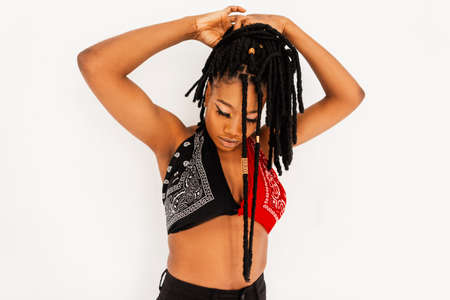 Beautiful woman in fashionable stylish clothes with bandana in studio