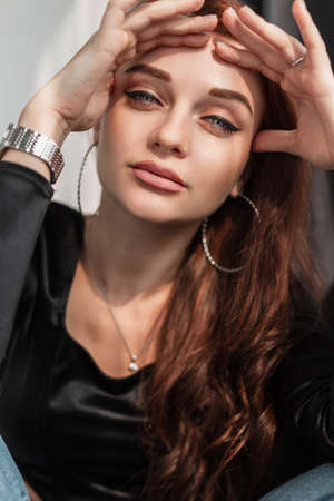 Cool female portrait of a beautiful young woman with a clean skin and blue amazing eyes looking at...