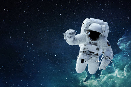 Spaceman astronaut with hamlet flying in blue deep space with stars.の写真素材
