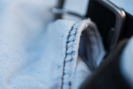 Blue jeans, macro. fashion denim textile and leather beltの写真素材