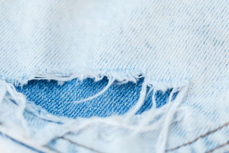 Blue denim texture. close up. Fashion ripped jeansの写真素材