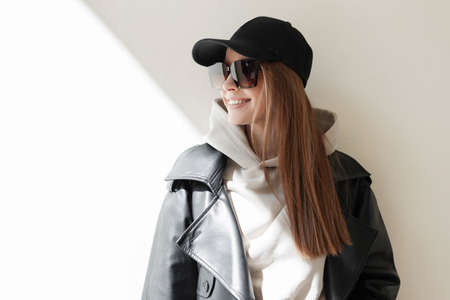 Stylish happy beautiful young woman model with fashion vintage sunglasses in fashionable clothes...