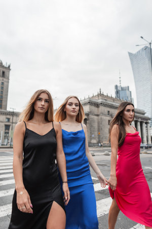 Beautiful elegant fashion girls in fashionable dresses walks in the cityの写真素材