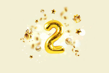 Golden number 2 is flying with golden confetti, gifts, mirror ball and stars balloons on a beige background with bokeh lights and sparks, creative idea. Winner and second place concept.の写真素材