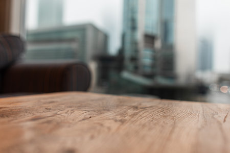 Vintage wooden table in a cafe on the urban background of the city. Free copy space for design and productの写真素材