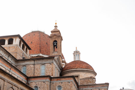 Beautiful ancient vintage church building with a bell on a tower in Italy, Florence