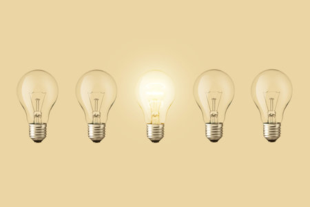 Electric light bulbs and one light bulbs on a beige background. think differently. creative idea, conceptの写真素材