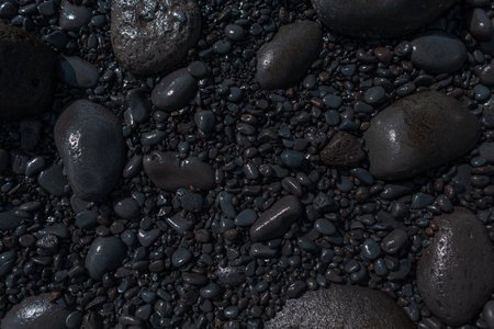 Stone black beach on the volcanic island of Madeira. Black texture of stones, top viewの写真素材
