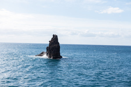 Beautiful blue ocean with stone cliff and blue skyの写真素材