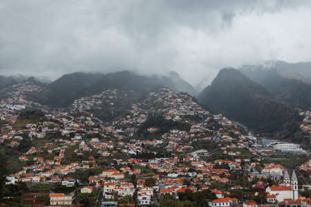 Beautiful mountain landscape with clouds and houses on the island of Madeiraの写真素材