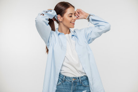 Cheerful beautiful girl with a pretty smile in fashion casual clothes with a stylish shirt, t-shirt...