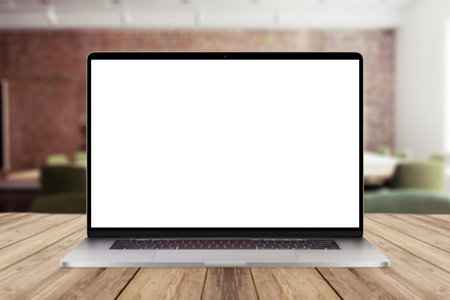 Laptop with white screen mockup display on wooden desktop with office view. creative ideas and work in officeの写真素材
