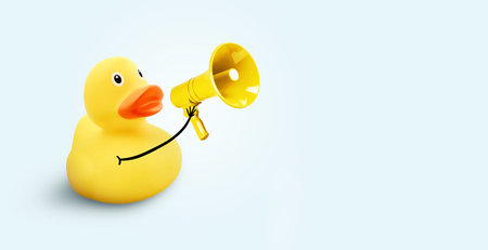 Creative funny yellow duck holding a loudspeaker on a blue background. Yellow press and news, concept. Marketing, creative idea. Driving traffic and attractionの写真素材