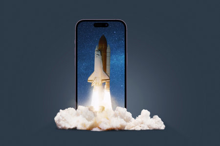 Rocket shuttle successful launch on a smartphone on a dark background, concept. Start up, gadget and take off of a spaceship with smoke. Overflow, creating an idea. Think differently. Appの写真素材