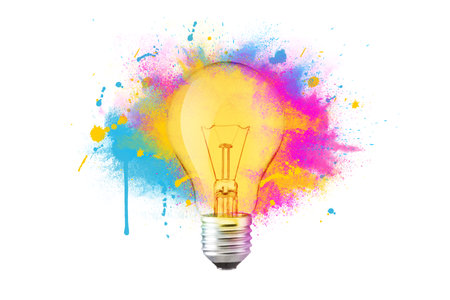 Creative colorful light bulb explosion with blue, yellow and pink splash on a white background, creativity idea. Light bulb and paint, concept. Think different. Paint with splashesの写真素材