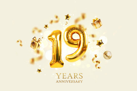 Gold festive balloons 19 years anniversary with golden confetti, presents, mirror ball and stars fly on a beige background with bokeh lights and sparks. Birthday luxury nineteen card, a creative ideaの写真素材