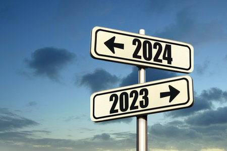 Road signs indicate the path to the new year 2024 and the old year 2023 on a blue sky, creative idea. Choose a new road, concept. Change for the betterの写真素材