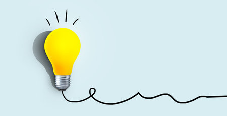 Creative yellow light bulb with shadow burns on a blue background, concept. Think differently, creative idea. Light came on. Brainstorm and thinking. Education and training. Free copy space. Successの写真素材