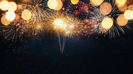 Beautiful golden fireworks on the starry sky with a yellow bokeh light. New Year 2024 and Christmas cardの写真素材
