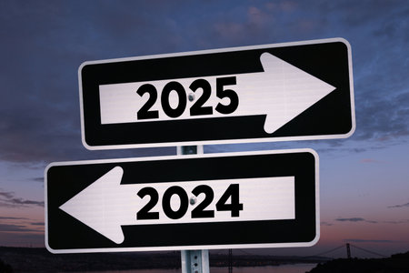 Road signs indicate the path to the new year 2025 and the old year 2024 at evening, creative idea. Choose a new road to 2025 year, concept. Change for the better.の写真素材