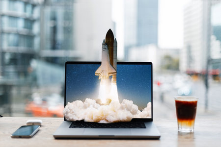 Creative laptop with space rocket taking off on desktop. Creative idea, concept. Go beyond the possible. Space shuttle rocket with smoke cloud takes off from laptop. Strategy and a successful startupの写真素材