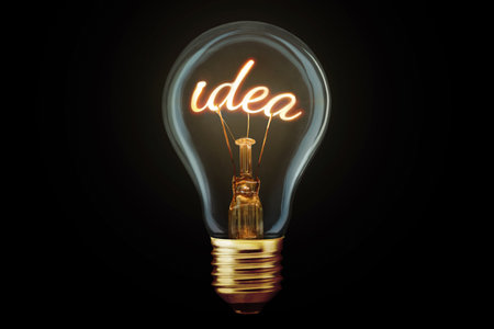 Creative light bulb with filament Idea glows on black background, concept. Think differently, creative idea. Marketing and generator of creative ideas. Creativityの素材