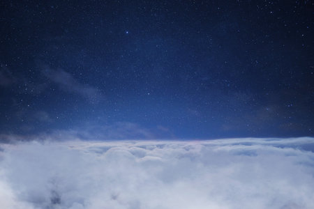 Beautiful starry sky space with clouds, concept. Traveling above the clouds. Flightの写真素材