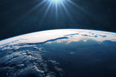 Amazing blue planet earth with ocean and clouds with sun light in open space on the starry sky....