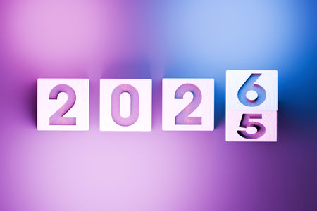 Flipping of 2025 to 2026 on wooden block cube for preparation new year change and start new business...