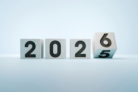 Wooden cubes displaying the numbers 2025 and 2026, representing the New Year, time change, future...