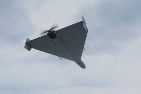 Combat military drone flies through the sky. Drone carrying explosives has crossed the border.の写真素材
