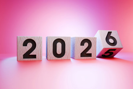 Wooden cubes with numbers forming 2026, symbolizing the upcoming new year, transition from 2025 to...