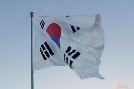 Korea national flag waving in the wind against a clear blue sky, symbolizing freedom, heritage, and pride. Patriotic concept. Travel, creative idea. Politics and Ethnicityの写真素材