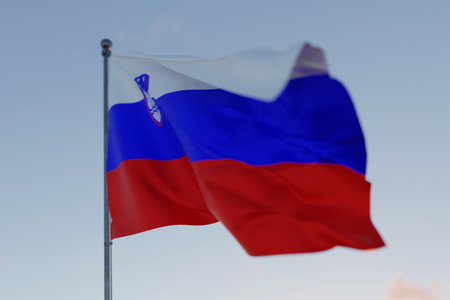 Slovenia national flag waving in the wind against a clear blue sky, symbolizing freedom, heritage, and pride. Patriotic concept. Travel, creative idea.の写真素材