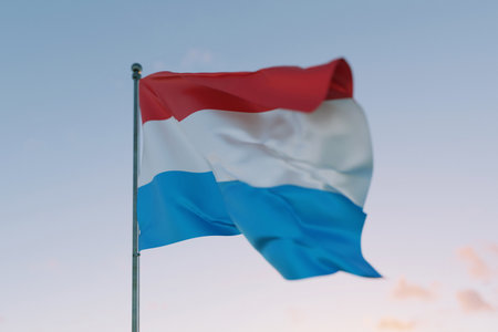 National flag of Luxembourg waving in the wind against a clear sky, symbolizing patriotism, independence, national pride, and unity.の写真素材