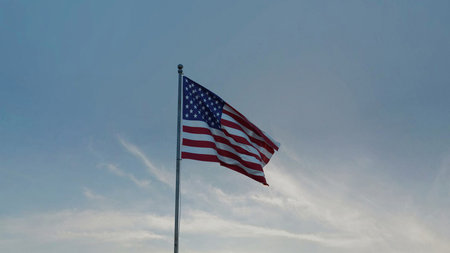 Stars and stripes of the USA flag waving outdoors, symbolizing unity, liberty, and American values.の写真素材