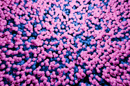 Abstract background with many pink and blue plastic balls, creating a colorful and playful texture. Suitable for concepts of fun, childhood, leisure, entertainment, or vibrant design.の写真素材
