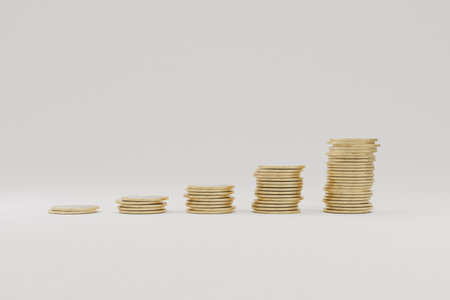 Stacked gold coins in ascending order symbolizing financial growth, investment success, profit...