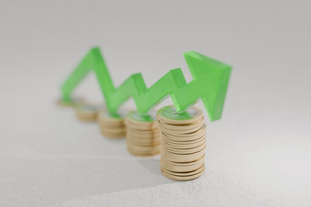 Concept of financial growth and successful investment. Increasing coin stacks with upward green...