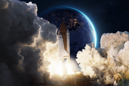 Space shuttle launching into the night sky with Earth visible in the background. Powerful flames and thick smoke mark the start of a cosmic journey. Elements of science, space, and exploration.の写真素材