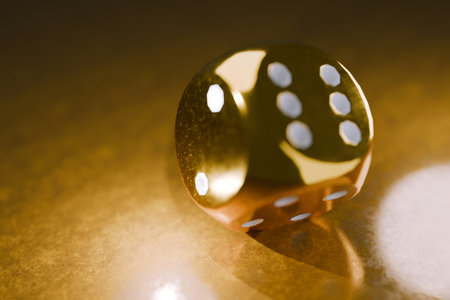 shiny golden die resting on a reflective surface, symbolizing luck, wealth, and chance. Perfect for casino, gambling, gaming, and luxury-themed concepts in advertising and design. Risk, creative ideaの写真素材