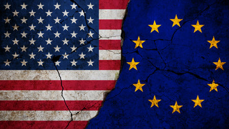 Flags of the United States and European Union are divided by a cracked surface concrete wall, symbolizing political or economic tensions, transatlantic conflict, international disagreement and diplomacy.の写真素材