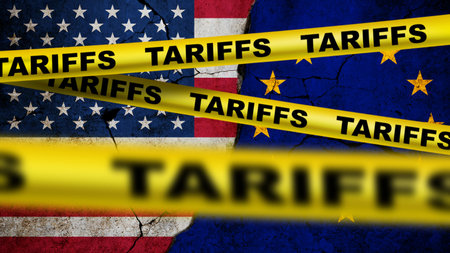 Flags of the USA and European Union separated by yellow tape marked "TARIFFS," symbolizing economic conflict, trade war, import taxes, and strained international trade relations.の写真素材