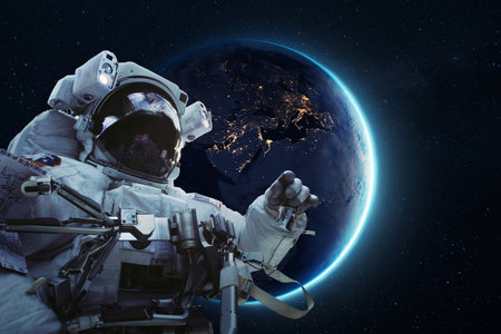 Astronaut floating in outer space with illuminated Earth in the background, showcasing space exploration, technology, and the beauty of our planet viewed from orbit. Spacemanの写真素材